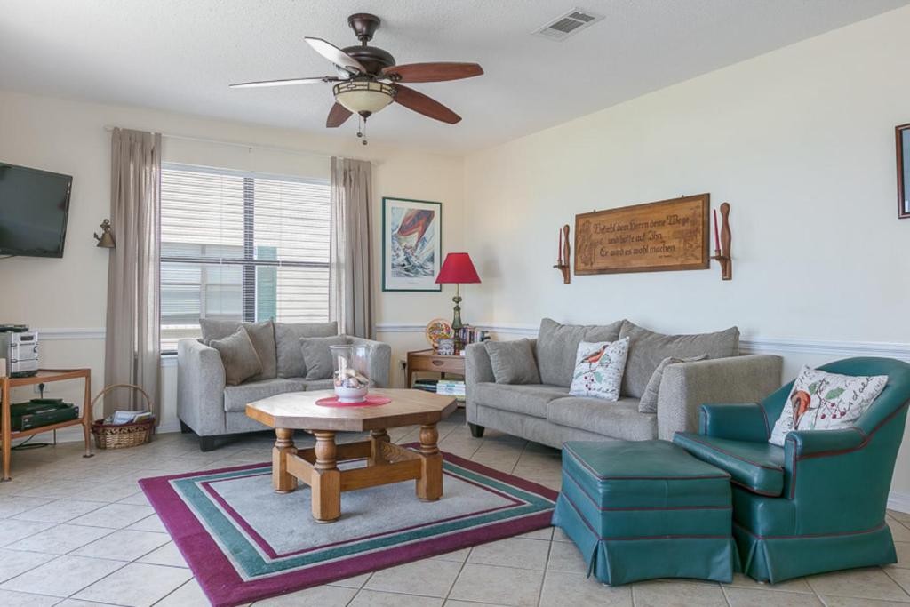 a living room with a couch and a table at Heron Landing in Gulf Shores