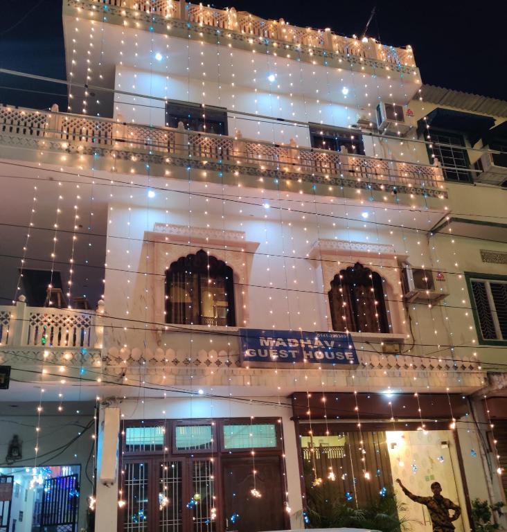 a building with christmas lights on it at Madhav Guest House in Jaipur