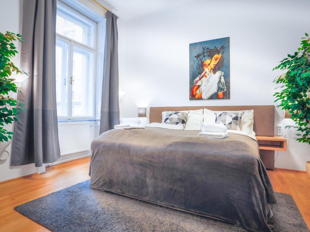 a bedroom with a large bed and a window at SKY9 Apartments City Center in Vienna