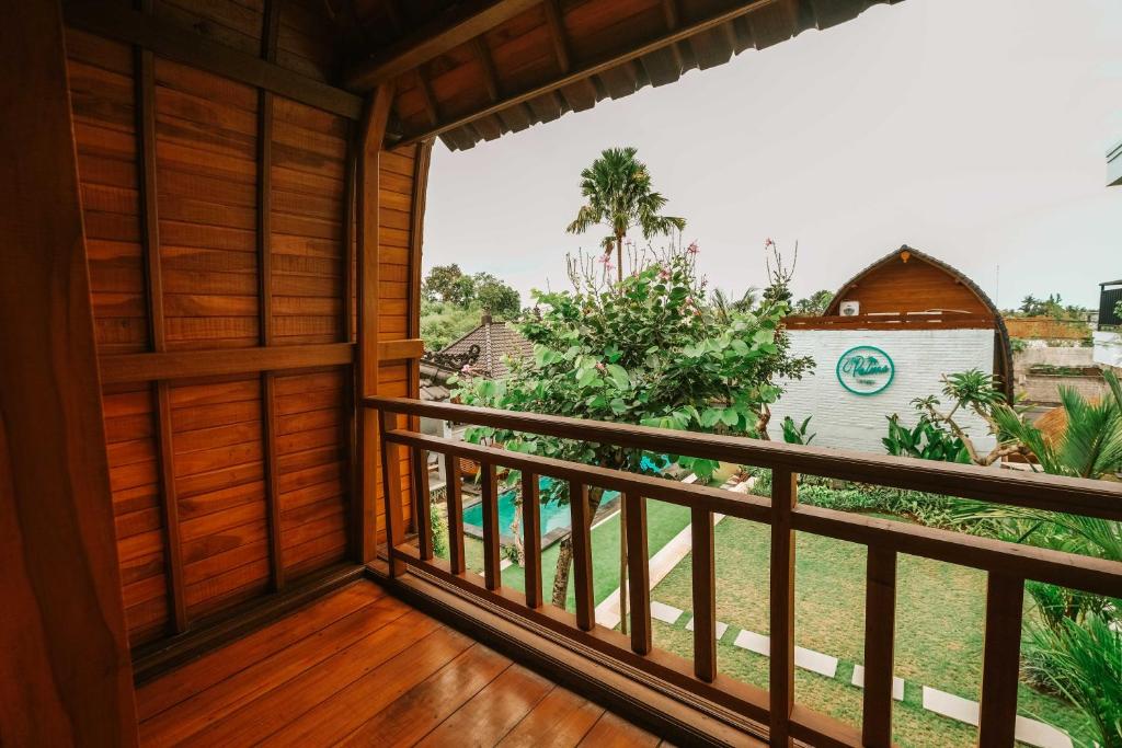 a balcony with a view of a yard at The Palms Canggu in Canggu