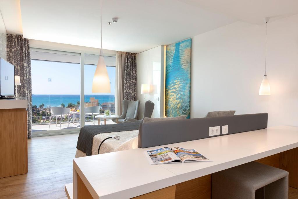 a bedroom with a bed and a desk in a room at Hipotels Playa de Palma Palace&Spa in Playa de Palma