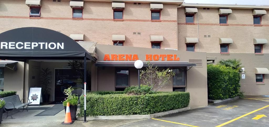 a hotel building with a sign for a hotel at Arena Hotel (formerly Sleep Express Motel) in Sydney