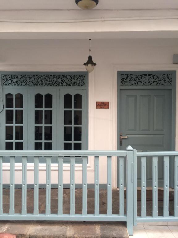 a front door of a house with a white fence at Fort Inn Guest House in Galle