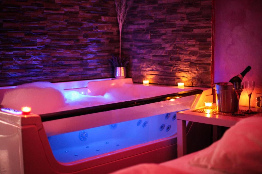 a hot tub in a room with candles in it at Spa Secret Apartmani in Belgrade