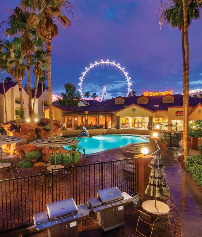 a resort with a large pool and a ferris wheel at Holiday Inn Club Vacations at Desert Club Resort in Las Vegas