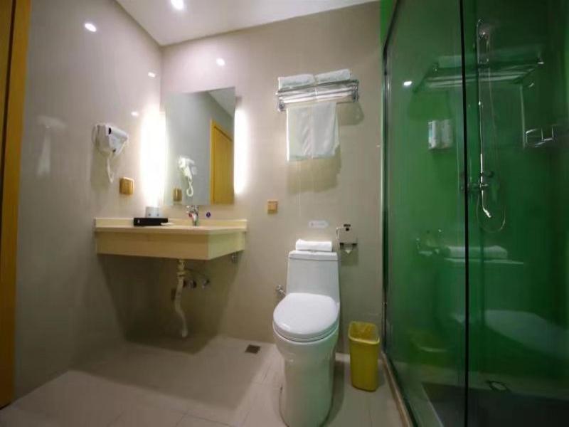 a bathroom with a toilet and a sink and a shower at GreenTree Inn Handan City Wu'an City Plaza Business Hotel in Handan