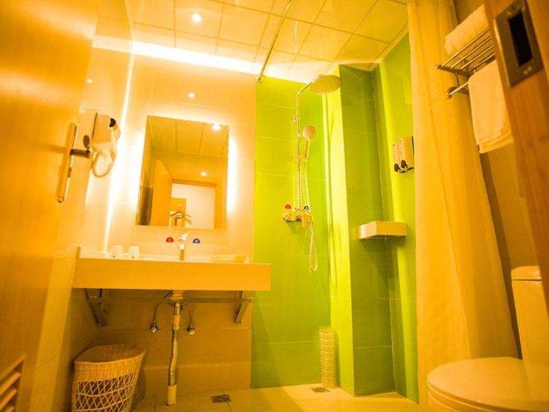 a green bathroom with a sink and a toilet at GreenTree Inn Yongnian County Hebei Shop Express Hotel in Handan