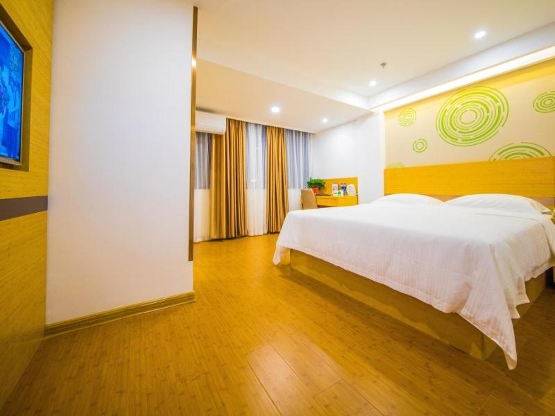 a bedroom with a large white bed in a room at GreenTree Inn Chuzhou Langya Mountain Scenic Area Xijian Road Business Hotel in Chuzhou
