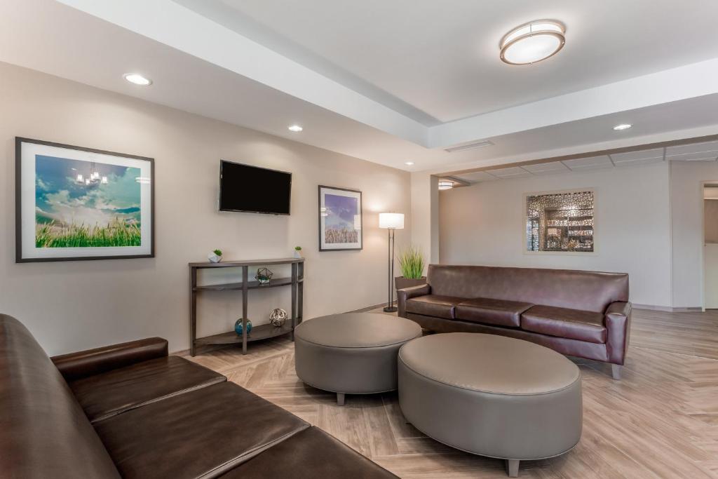 a waiting room with leather furniture and a flat screen tv at Candlewood Suites Bethlehem South by IHG in Bethlehem