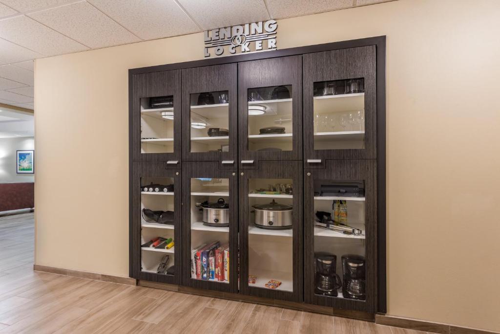 a display cabinet in a room with a wall at Candlewood Suites Bethlehem South by IHG in Bethlehem