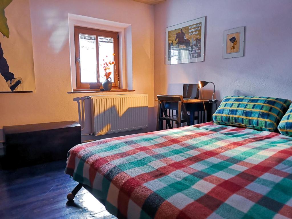 a bedroom with a bed and a window and a table at Kranjska Gora Family Break in Kranjska Gora