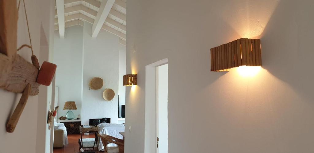 a room with a hallway with a light on the wall at Comporta House in Comporta