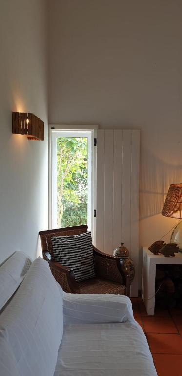 a bedroom with two beds and a window at Comporta House in Comporta