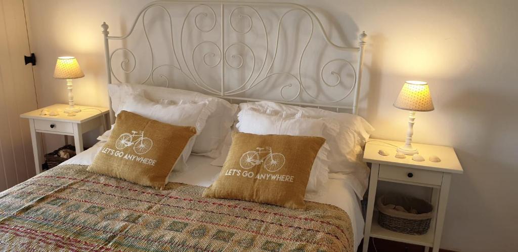 a bedroom with a bed with a bicycle pillow on it at Comporta House in Comporta