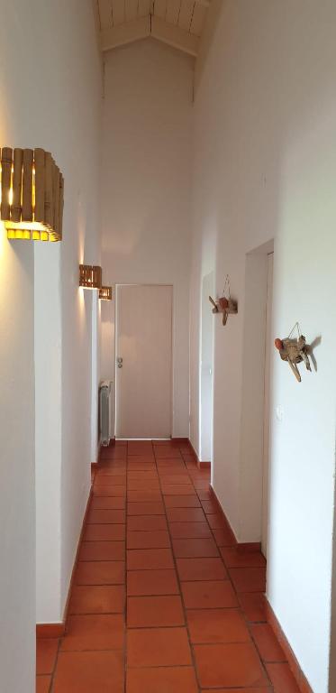 an empty hallway with two planes on the wall at Comporta House in Comporta