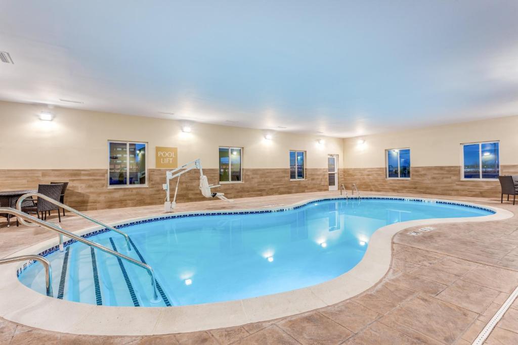 a large swimming pool in a hotel room at Candlewood Suites Bethlehem South by IHG in Bethlehem