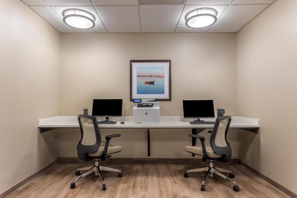 an office with two desks with two monitors and two chairs at Candlewood Suites Bethlehem South by IHG in Bethlehem