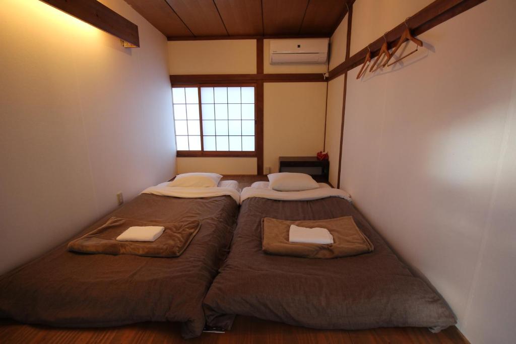 Postel nebo postele na pokoji v ubytování Roku Hostel Hiroshima