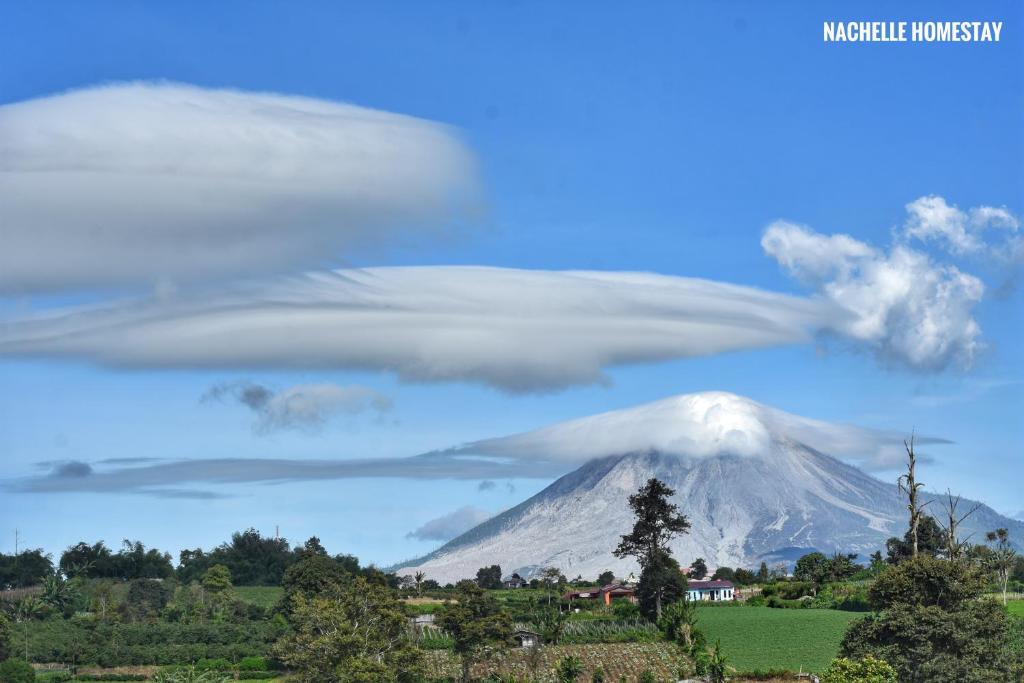 a lenticular cloud over a snowcovered mountain at Nachelle Homestay in Berastagi