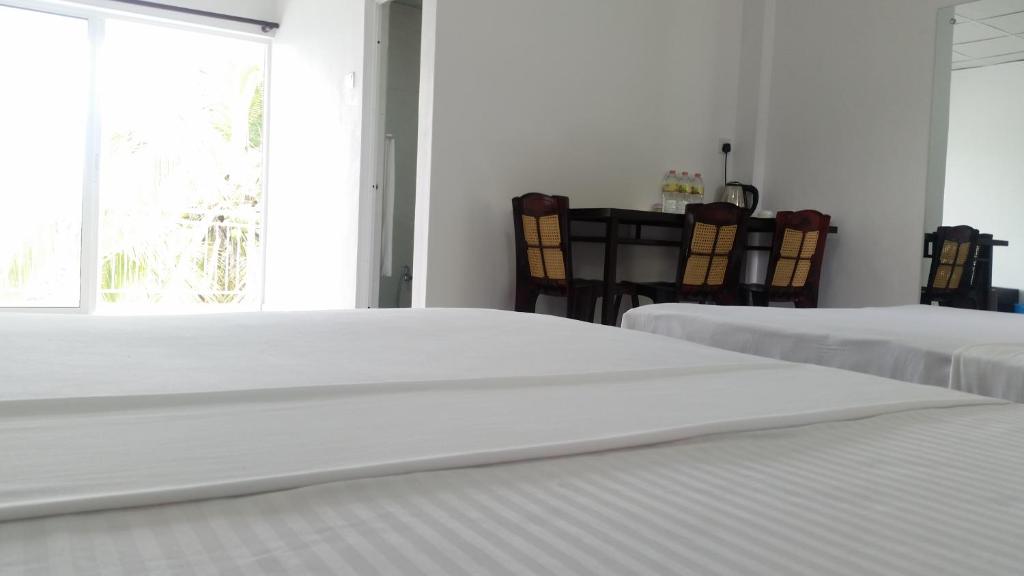 Postel nebo postele na pokoji v ubytování Mahaweli View Inn