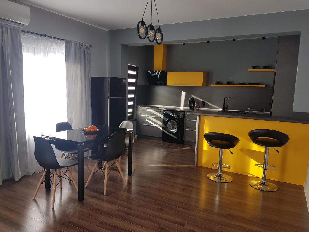 a kitchen with a table and chairs and a dining room at LUXURY SUITES in Karlovo