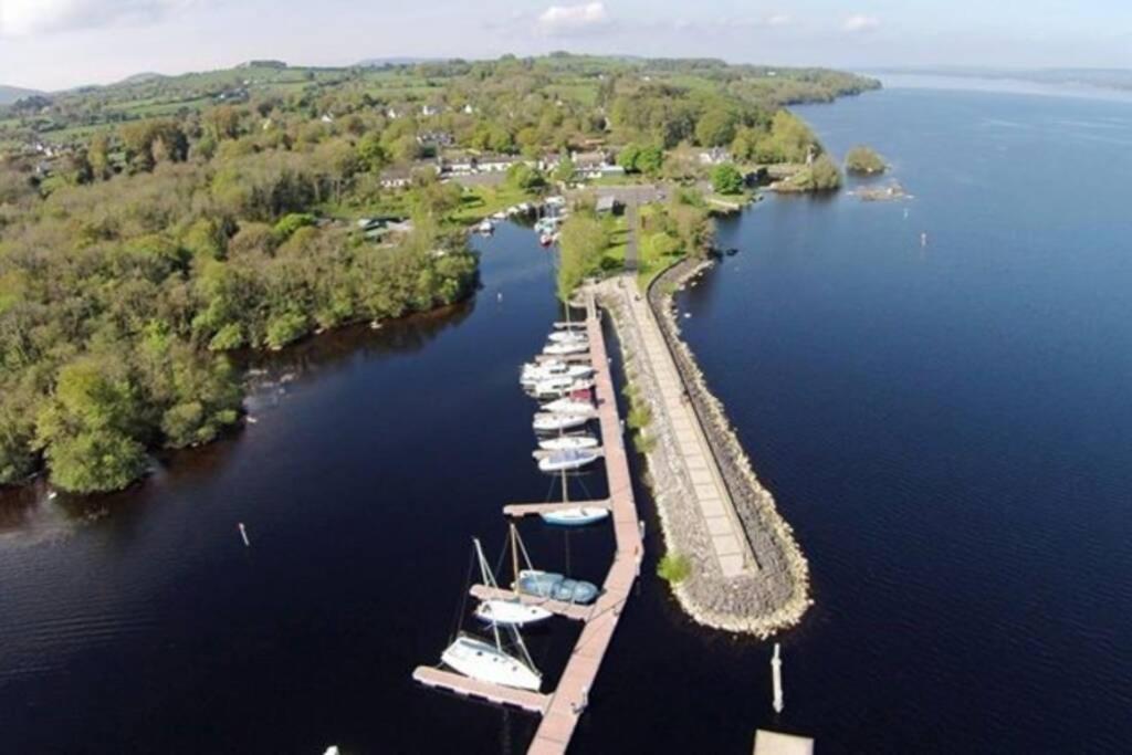 a group of boats docked at a dock in a lake at Garrykennedy Harbour View Apartment in Nenagh