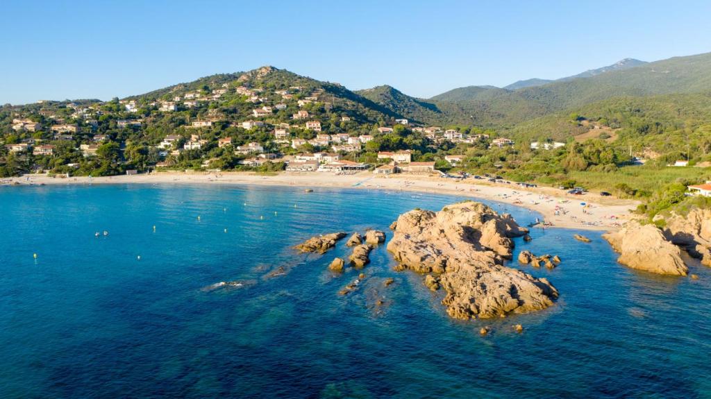 an aerial view of a beach with rocks in the water at Hotel le Jardin d'Emile in Porticcio