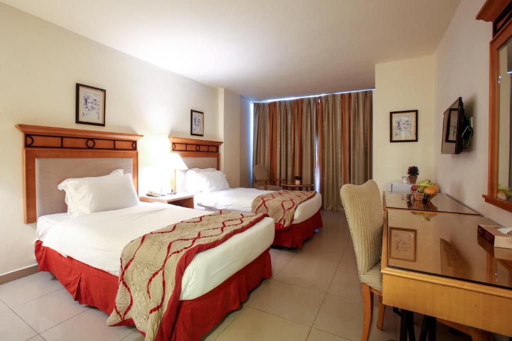 Postel nebo postele na pokoji v ubytování Mina Hotel
