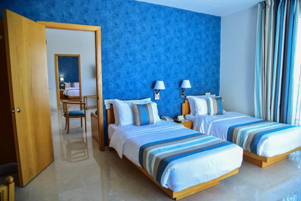 Postel nebo postele na pokoji v ubytování Casa D'or Hotel