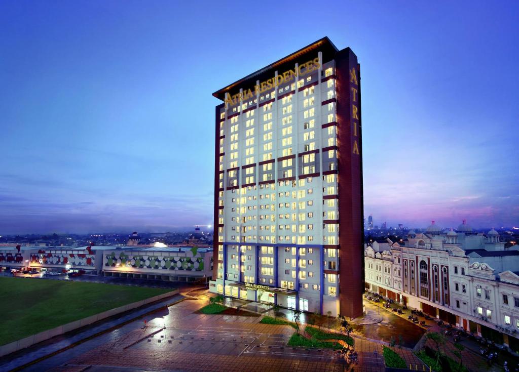 a tall building with many windows at night at Atria Residences Gading Serpong in Serpong