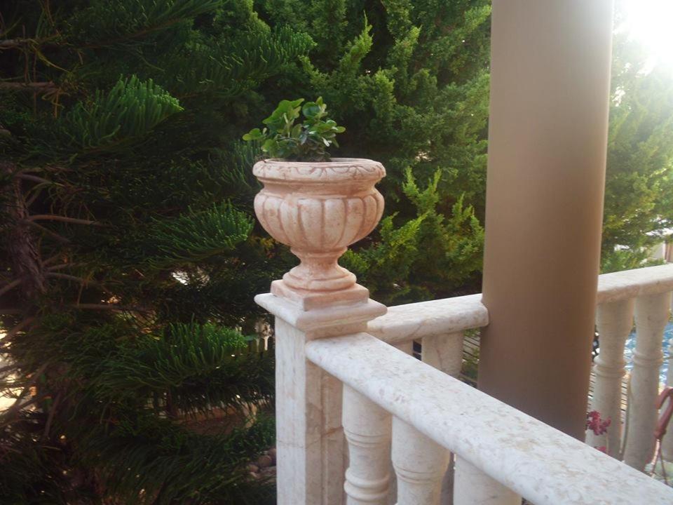 a vase sitting on a railing on a porch at anastasia holiday apartments in Paphos City