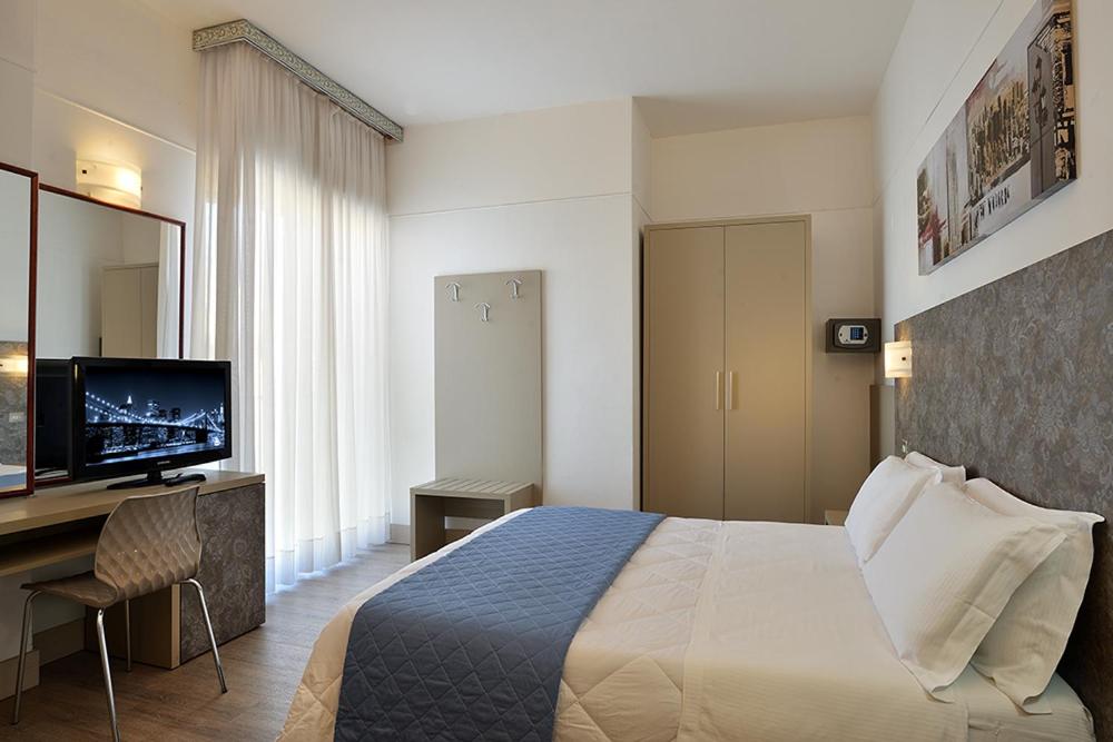 Postel nebo postele na pokoji v ubytování Hotel Tiberius