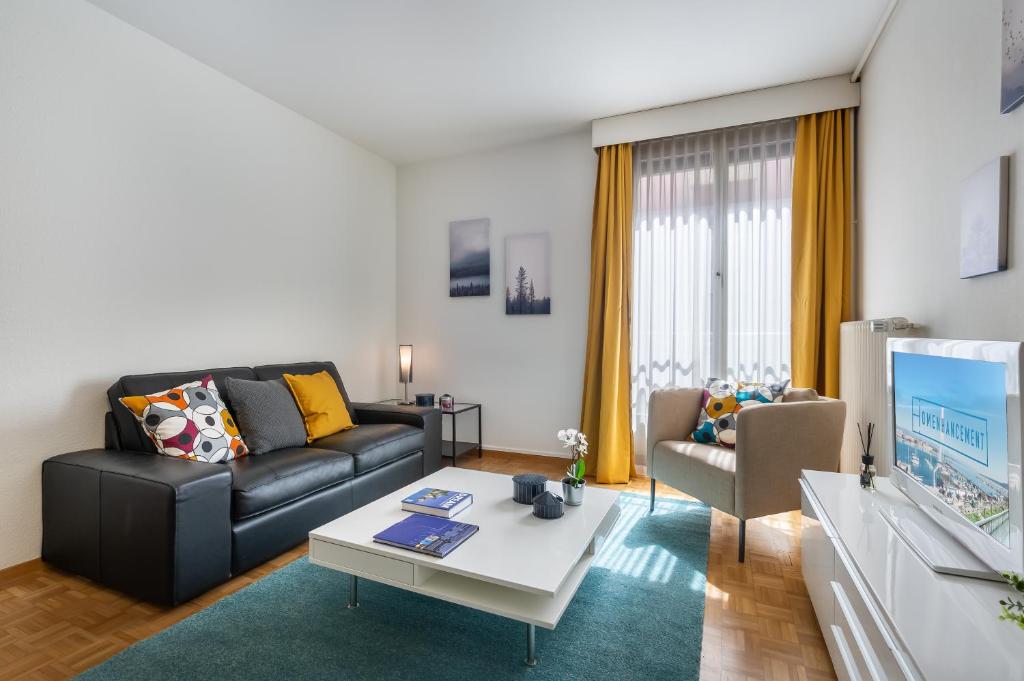 a living room with a couch and a table at Richemont Residence by Homenhancement in Geneva