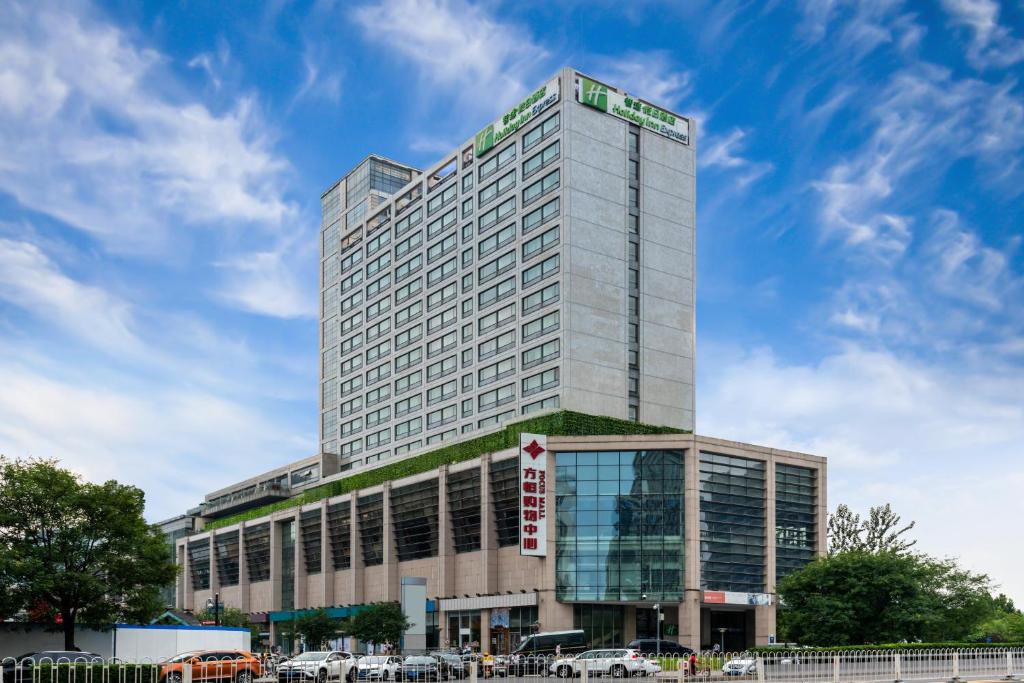 a tall building with cars parked in front of it at Holiday Inn Express Beijing Wangjing, an IHG Hotel in Beijing