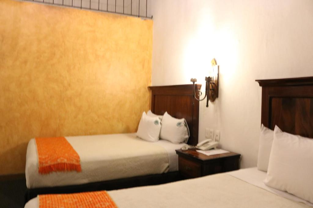 Postel nebo postele na pokoji v ubytování Hotel Historia