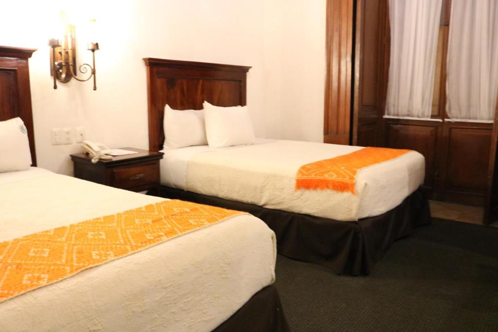 Postel nebo postele na pokoji v ubytování Hotel Historia