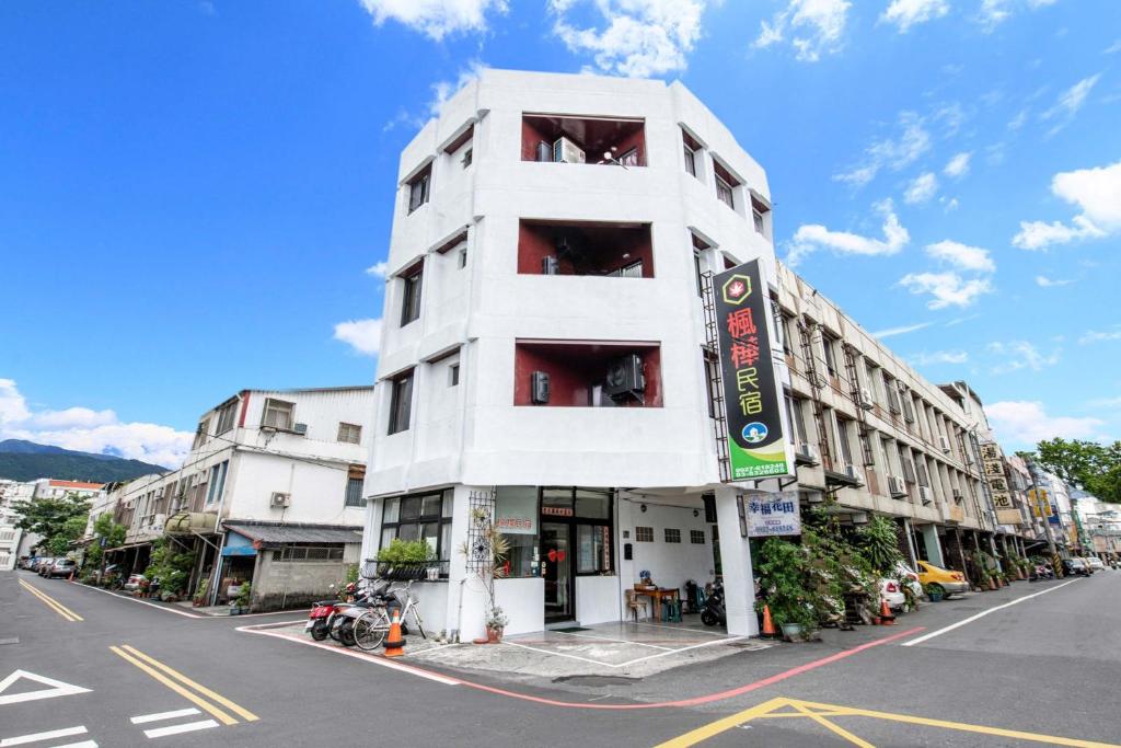 a white building on the side of a street at Ribbed Birch B&B in Hualien City