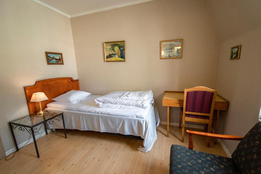 Postel nebo postele na pokoji v ubytování Grand Hotel Hønefoss