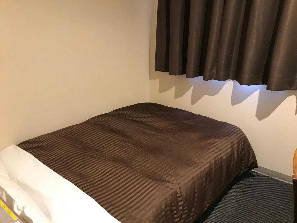 Postel nebo postele na pokoji v ubytování Hotel Avan Sukumo