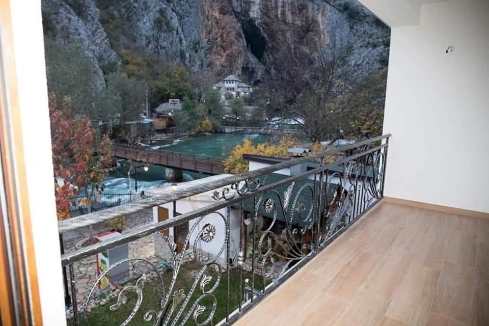 a room with a balcony with a mountain view at Villa Bunski biser in Blagaj