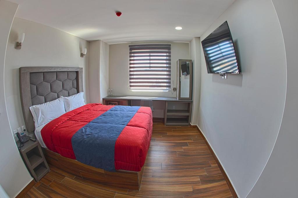 Llit o llits en una habitació de Hotel ANB Aeropuerto Guadalajara