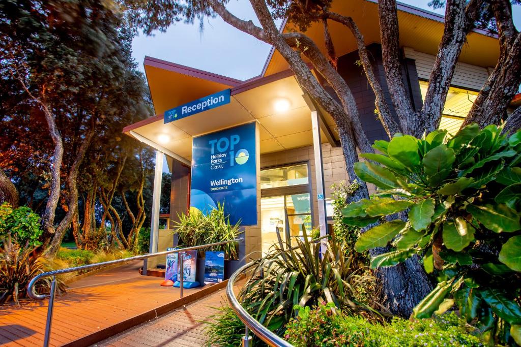 a building with a sign in front of it at Wellington TOP 10 Holiday Park in Lower Hutt