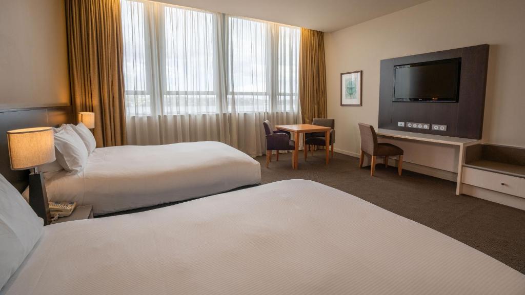 Postel nebo postele na pokoji v ubytování Scenic Hotel Dunedin City