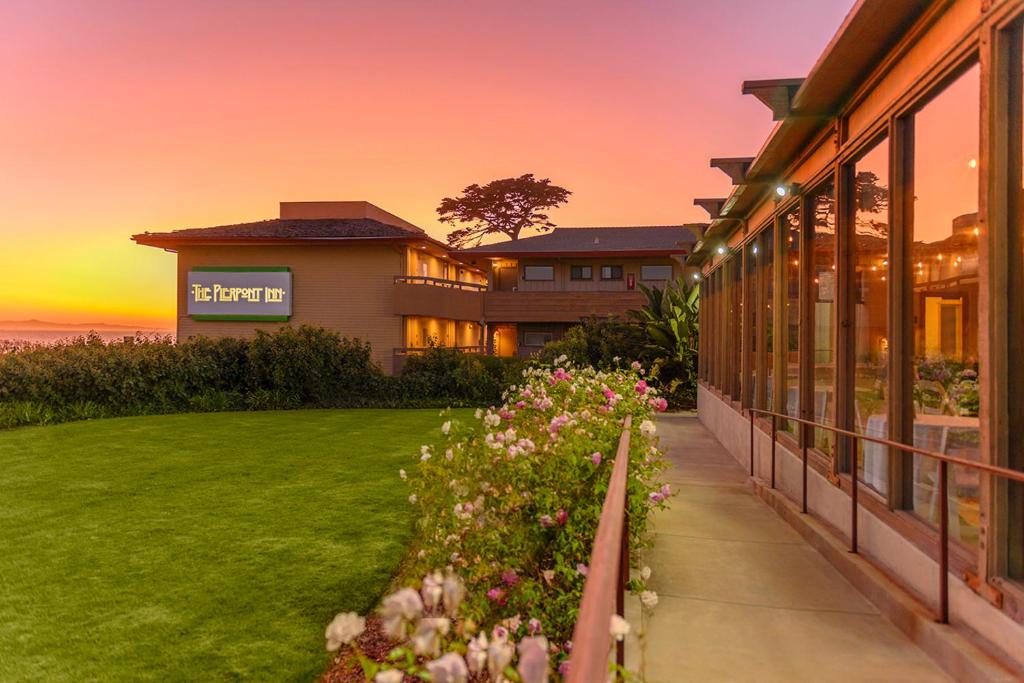 a building with a sunset in the background at The Pierpont Inn in Ventura