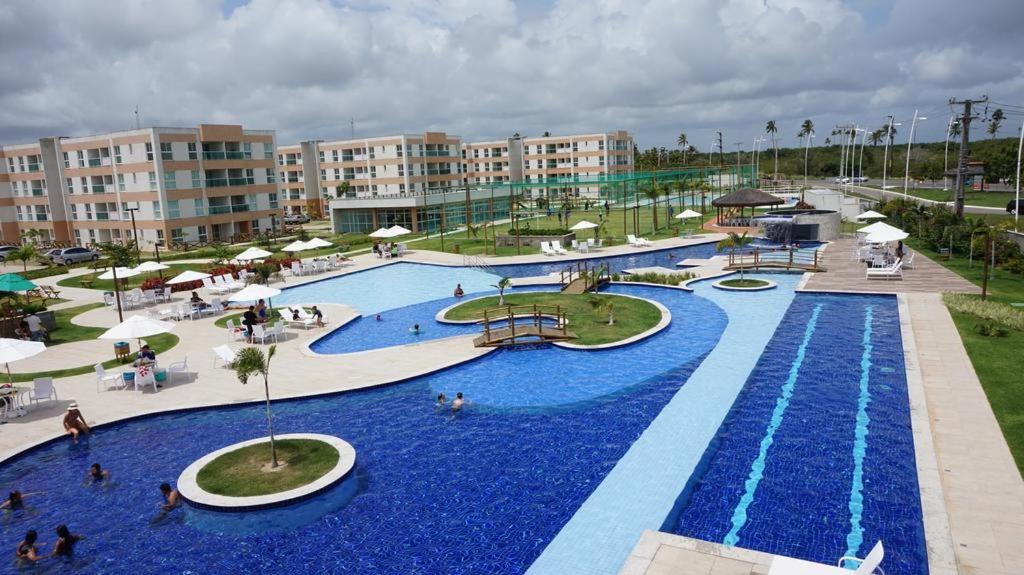 a large pool with blue water in a resort at Porto de Galinhas - Muro Alto Condomínio Clube in Ipojuca