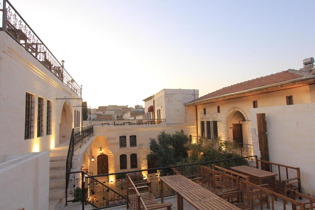 een balkon met tafels en stoelen in een gebouw bij nahrin hotel&art in Sanlıurfa