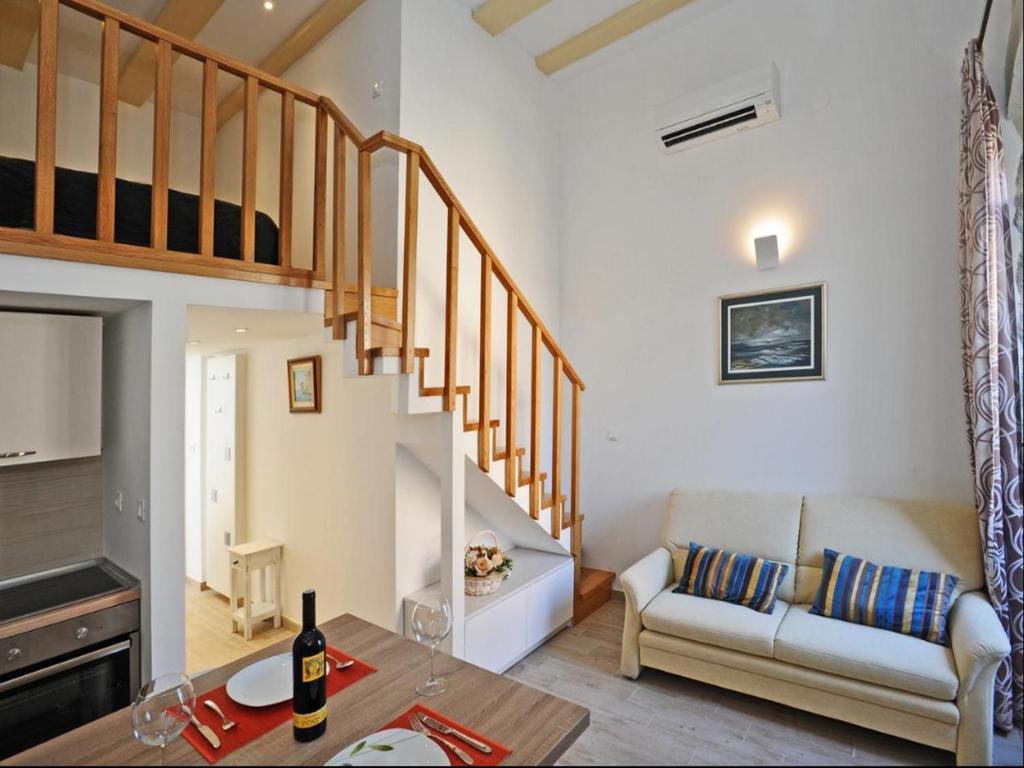 ein Wohnzimmer mit einer Treppe und einer Couch in der Unterkunft Atento Apartments in Dubrovnik