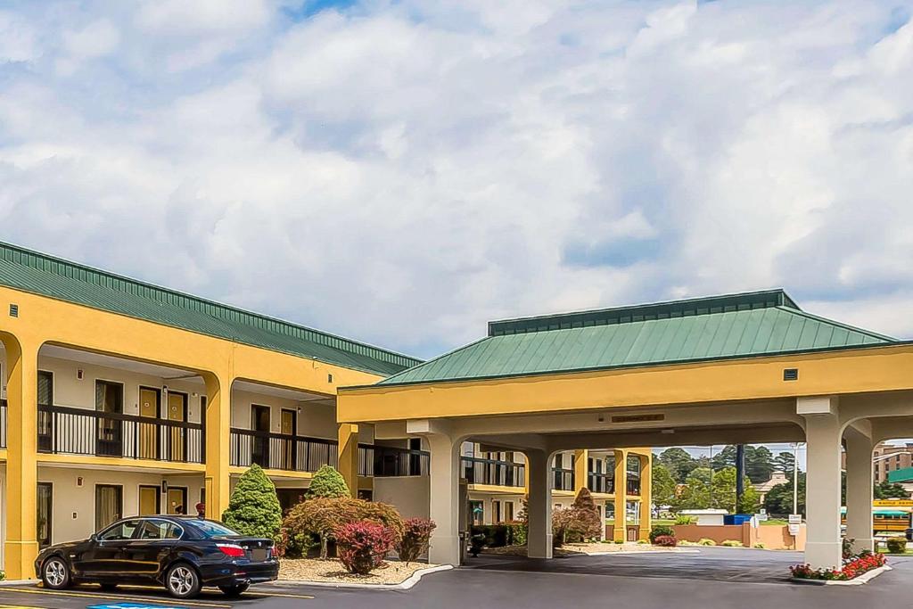 un'auto parcheggiata di fronte a un grande edificio di Rodeway Inn Knoxville a Knoxville