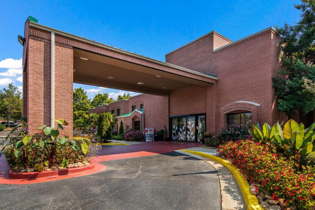 a red brick building with a parking lot at Sleep Inn near The Avenue in Peachtree City