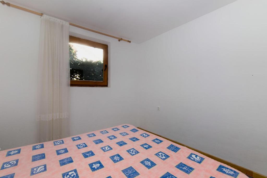 Postel nebo postele na pokoji v ubytování Apartments Jaksa
